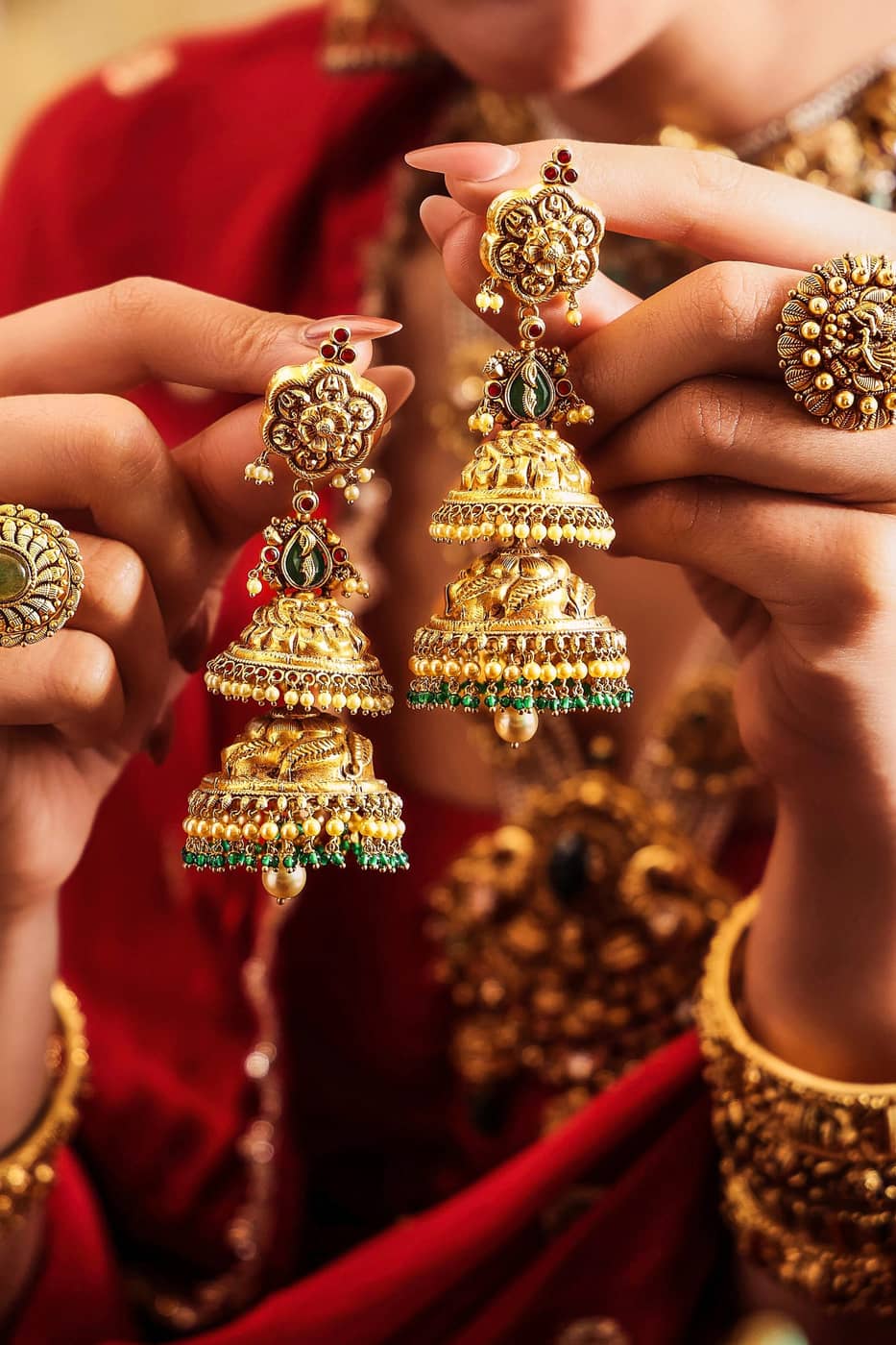 Ornate gold jewelry with red and green gems