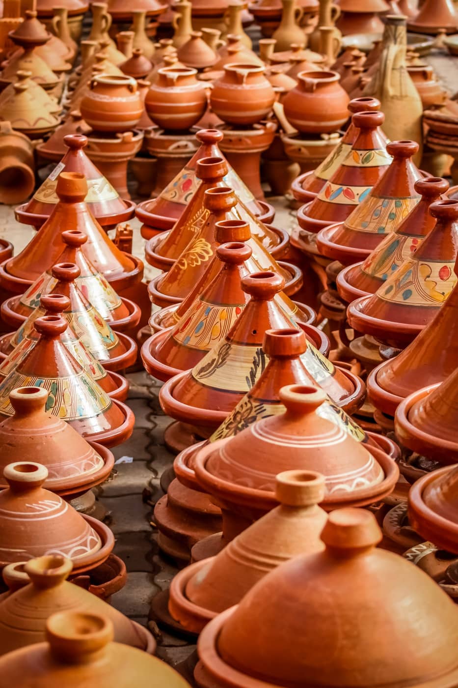 Rows of terracotta cookware and pottery
